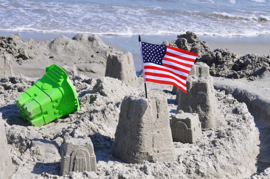 American Flag in sandcastle on the beach