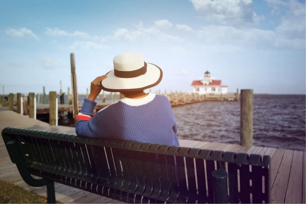 Woman sitting on the Manteo Waterfront